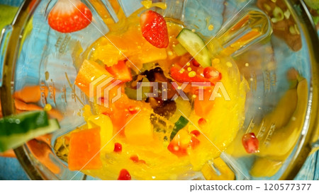 Fresh fruit and vegetables smoothie blended in blender, top view. Healthy eating concept. Freeze motion. 120577377