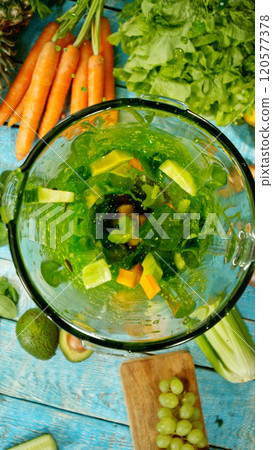 Fresh fruit and vegetables smoothie blended in blender, top view. Healthy eating concept. Freeze motion. 120577378