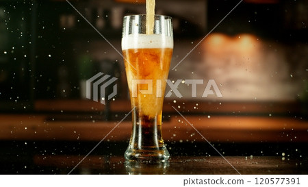 Close-up of beer pouring into pint , freeze motion. 120577391