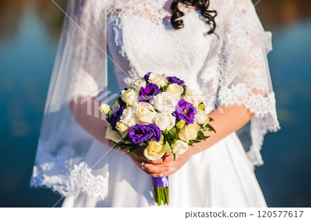 The bride with a wedding bouquet of roses The bride with a wedding bouquet of roses 120577617