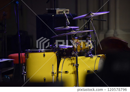 Yellow drum kit musical instrument on stage 120578796