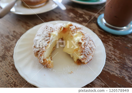 choux cream or cream puff, eclair in a small dish 120578949