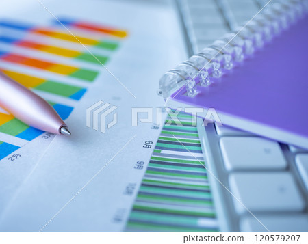 Graph, keyboard and notebook placed on the table 120579207
