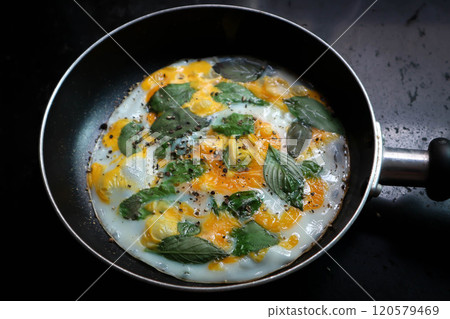 fried egg with sweet basil and holy basil in the pan fried egg with sweet basil and holy basil in the pan 120579469