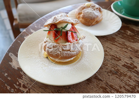 choux cream or cream puff, eclair or strawberry choux cream and coffee choux cream or cream puff, eclair or strawberry choux cream and coffee 120579470