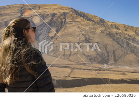 Young tourist with sunglasses looking at the scenery of Northern Argentina. 120580026