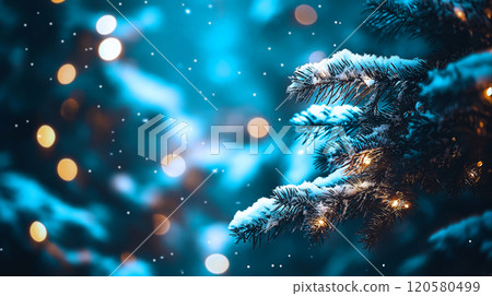 Snow-covered pine branches illuminated by soft, warm lights, set against blurred, dreamy winter background. Delicate snowfall creates peaceful, festive ambiance, perfect for holiday, winter designs 120580499