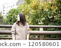Woman standing on bridge 120580601