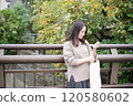 Woman standing on bridge 120580602