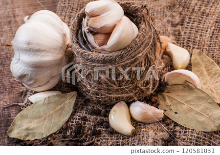 garlic on a wooden table.Fresh organic garlic bulbs on wooden surface - rustic kitchen ingredient garlic on a wooden table.Fresh organic garlic bulbs on wooden surface - rustic kitchen ingredient 120581031