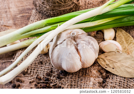 garlic on a wooden table.Fresh organic garlic bulbs on wooden surface - rustic kitchen ingredient garlic on a wooden table.Fresh organic garlic bulbs on wooden surface - rustic kitchen ingredient 120581032