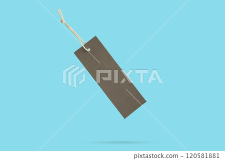 Blank price tag tied with string float on blue background Blank price tag tied with string float on blue background 120581881