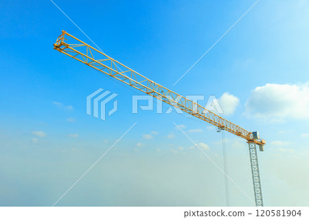 Industrial construction crane with blue sky background at building site Industrial construction crane with blue sky background at building site 120581904