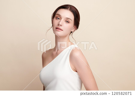 Beautiful young woman with clean fresh skin on beige background, Face care, Facial treatment, Cosmetology, beauty and spa, women portrait. 120582071