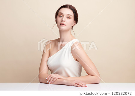 Beautiful young woman with clean fresh skin on beige background, Face care, Facial treatment, Cosmetology, beauty and spa, women portrait. 120582072