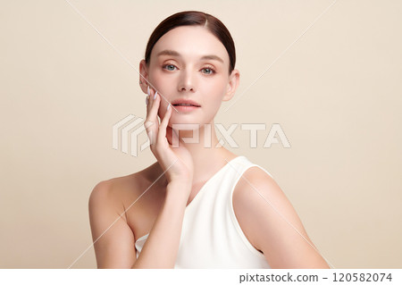 Beautiful young woman with clean fresh skin on beige background, Face care, Facial treatment, Cosmetology, beauty and spa, women portrait. Beautiful young woman with clean fresh skin on beige background, Face care, Facial treatment, Cosmetology, beauty and spa, women portrait. 120582074