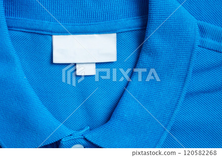 Blank white laundry care clothes label on blue shirt fabric texture background Blank white laundry care clothes label on blue shirt fabric texture background 120582268