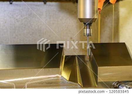 The CNC milling machine finishing cut the mold parts with liquid coolant method. 120583845