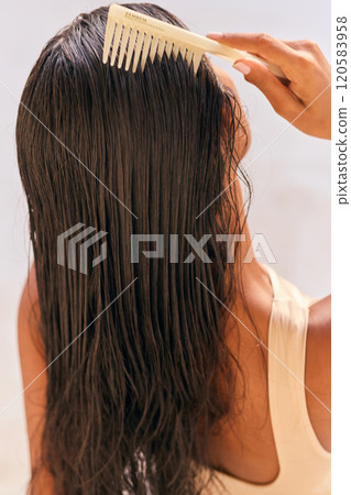 Hair Care Woman Combing Long Wet Hair for Smooth and Healthy Look 120583958