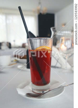 Large glass with traditional Christmas homemade glogg on the holiday table. Selective focus. 120583992