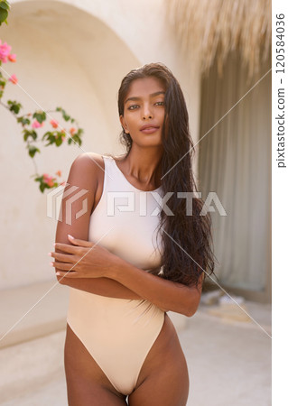 Elegant Woman Posing in Stylish Swimwear During Sunny Vacation Elegant Woman Posing in Stylish Swimwear During Sunny Vacation 120584036