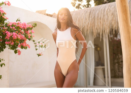 Elegant Woman in Stylish Swimsuit Enjoying Sunny Summer Day Outdoors Elegant Woman in Stylish Swimsuit Enjoying Sunny Summer Day Outdoors 120584039