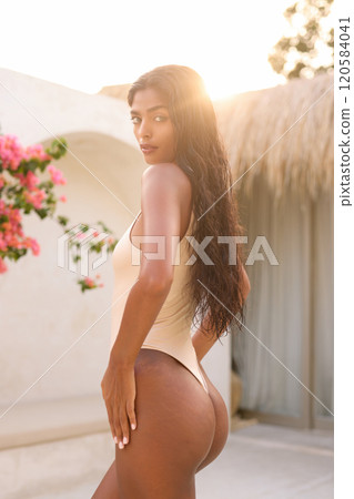 Summer Fashion: Elegant Woman in Swimsuit Amidst Exotic Tropical Setting Summer Fashion: Elegant Woman in Swimsuit Amidst Exotic Tropical Setting 120584041