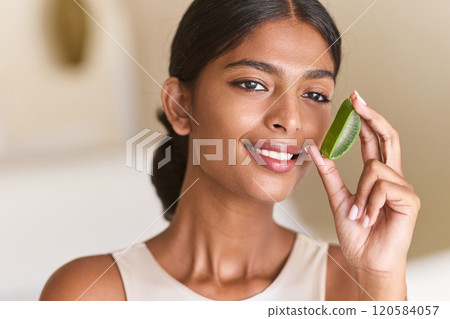 Skin Care Aloe. Radiant Woman Holding Aloe Vera for Natural Skincare and Beauty 120584057