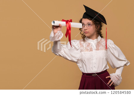 Graduate in cap and gown holding diploma scroll Graduate in cap and gown holding diploma scroll 120584580