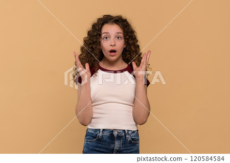 A surprised young girl with curly hair, expressing shock A surprised young girl with curly hair, expressing shock 120584584
