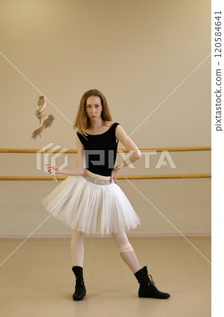 Ballerina in shoes and tutu, holding ballet slippers Ballerina in shoes and tutu, holding ballet slippers 120584641