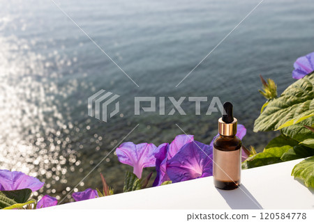 Serum bottle with ocean and flowers in the background Serum bottle with ocean and flowers in the background 120584778