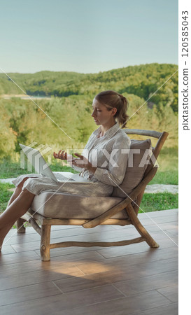 Woman having video meeting while working outdoors 120585043