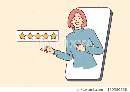 Positive woman gives five stars in mobile application, shows thumbs up, looking out of smartphone Positive woman gives five stars in mobile application, shows thumbs up, looking out of smartphone 120586368