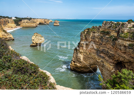 Praia da Marinha Beach among rock islets and cliffs seen from Seven Hanging Valleys Trail, Algarve, Portugal 120586659