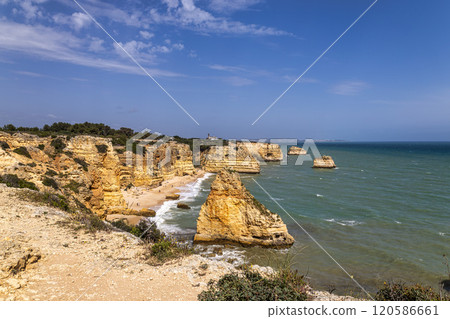 Praia da Marinha Beach among rock islets and cliffs seen from Seven Hanging Valleys Trail, Algarve, Portugal Praia da Marinha Beach among rock islets and cliffs seen from Seven Hanging Valleys Trail, Algarve, Portugal 120586661