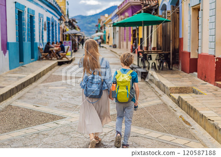Mother and her son tourists walks through the colonial streets San Cristobal de las Casas, Mexico. Cultural exploration, architecture, and travel experience concept 120587188