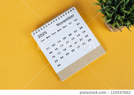 November 2025 desk calendar on yellow background. Directly above. Flat lay November 2025 desk calendar on yellow background. Directly above. Flat lay 120587682