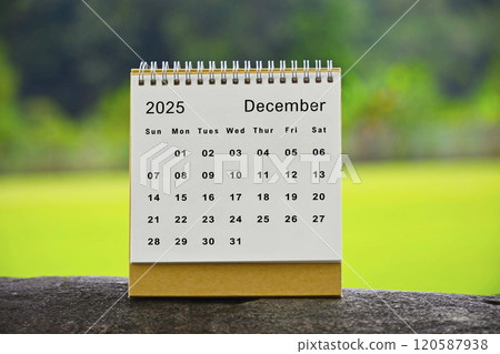 December 2025 white calendar with green blurred background - New year concept 120587938