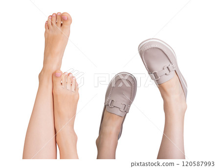 Pair of stylish leather loafers with chic chain decor beside bare feet. Modern slip on design with 120587993
