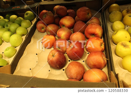 red and green apples in the store in cardboard boxes. Selling and buying fruit in the store 120588330