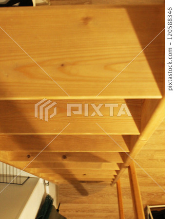 A wooden staircase is seen from top to bottom. Stairs in apartments 120588346
