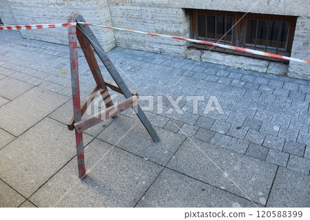 red white fencing tape. Allocation of the hazardous zone of the construction site 120588399