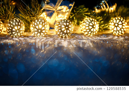 Beautiful Christmas decorations displayed with a gift box in the background Beautiful Christmas decorations displayed with a gift box in the background 120588535