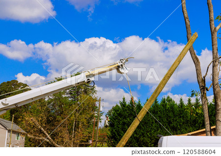 Severe hurricane has damaged electric pole power lines, which are being replaced 120588604