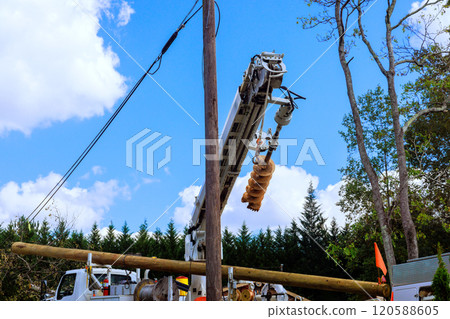Storm damaged electric pole power lines is being replaced after severe hurricane 120588605