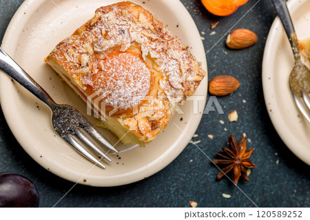 Cottage cheese pie with apricot and plum. Top view. 120589252