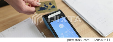 Female person puts card to modern terminal trying to pay Female person puts card to modern terminal trying to pay 120589411