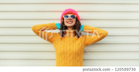 Winter christmas portrait of happy relaxed woman smiling in yellow sweater, hat on white background 120589730
