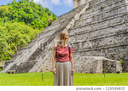 Female tourist exploring the ancient pyramids of Palenque, Mexico, surrounded by dense jungle. Cultural heritage and adventure travel concept 120589832